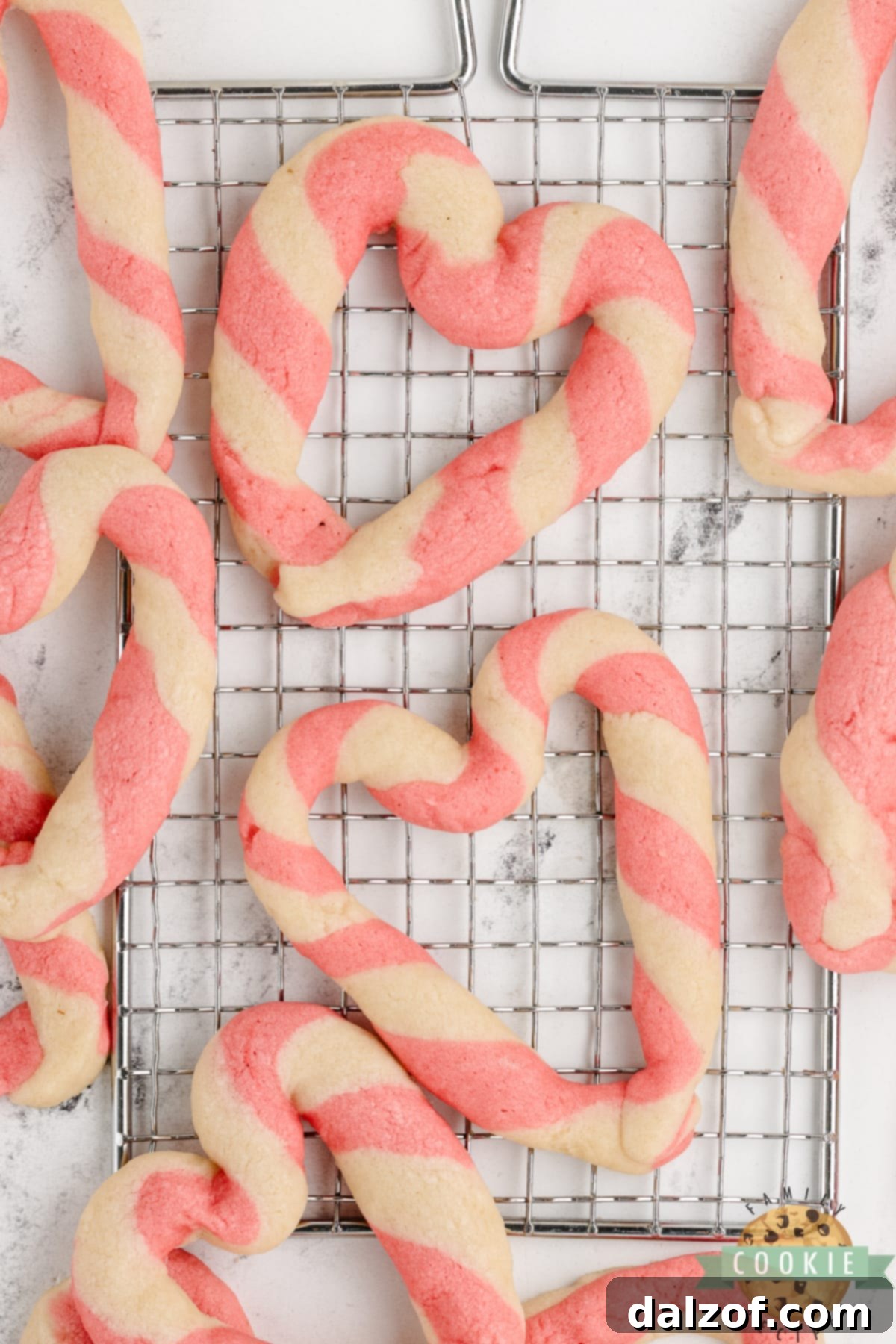 A delicious plate of Braided Sweetheart Cookies, featuring elegant pink and white striped hearts, ready to be enjoyed as a simple sugar cookie treat.