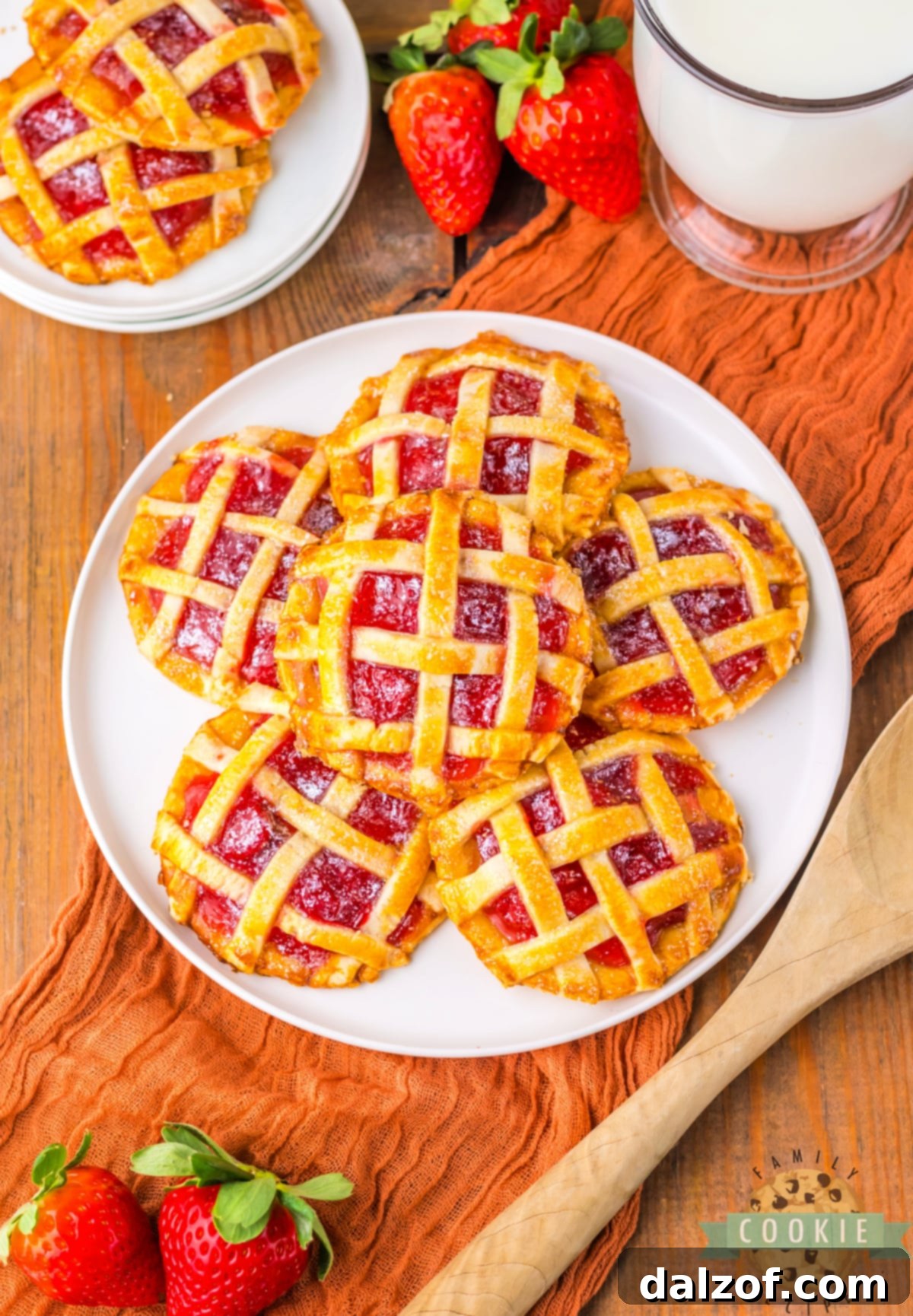 An inviting display of mini strawberry pies, freshly baked and ready to be enjoyed.