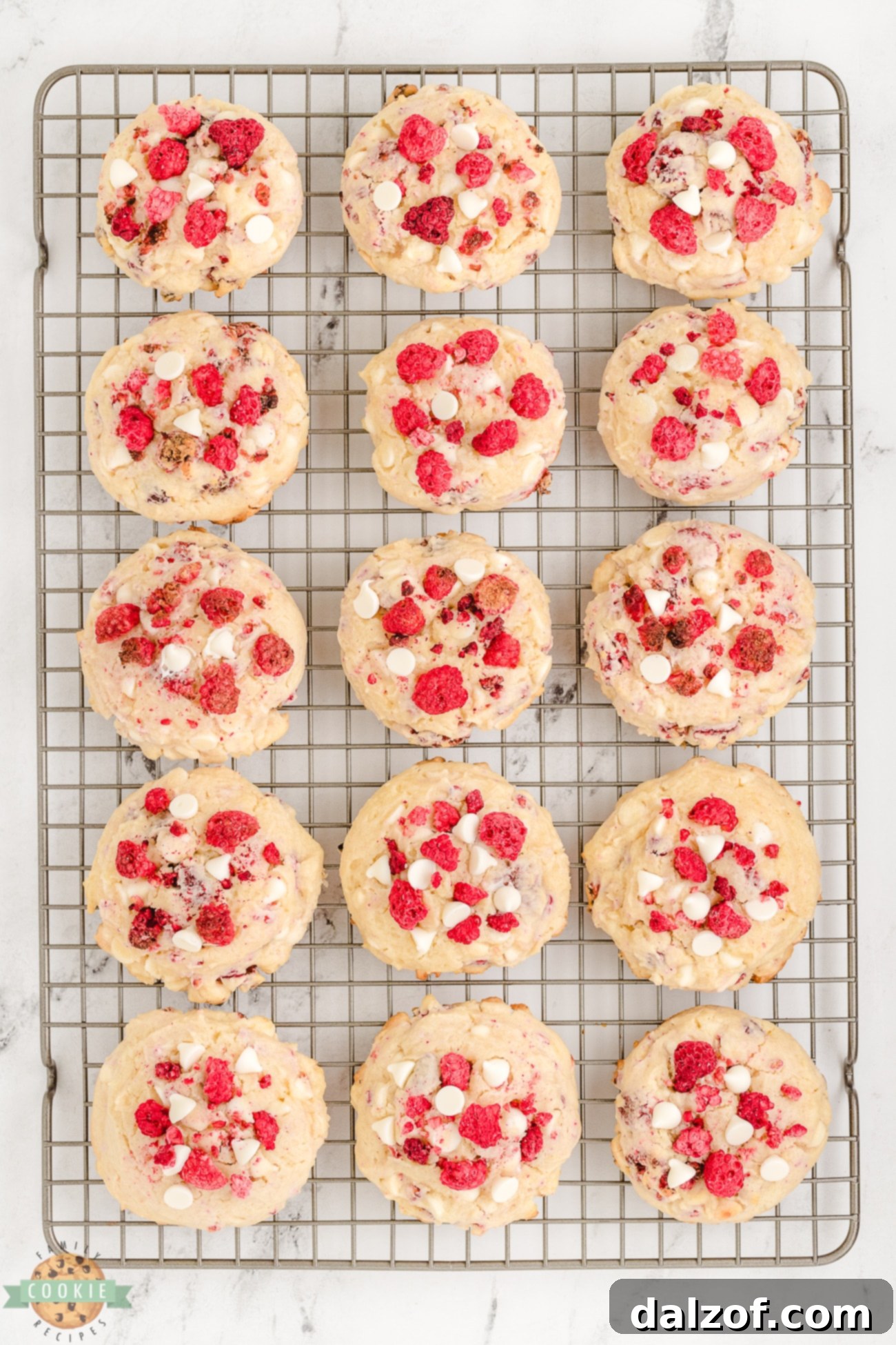 Raspberry cheesecake cookies cooling on a wire rack