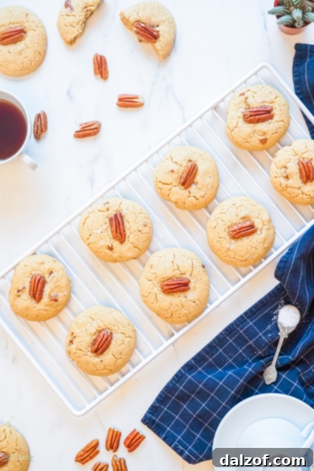 Close-up of baked Butter Pecan Cookies, emphasizing their soft, golden appearance and visible pecan pieces