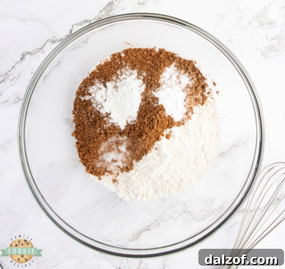 An assortment of dry ingredients perfectly measured and ready for mixing to create the chocolate cookie base.