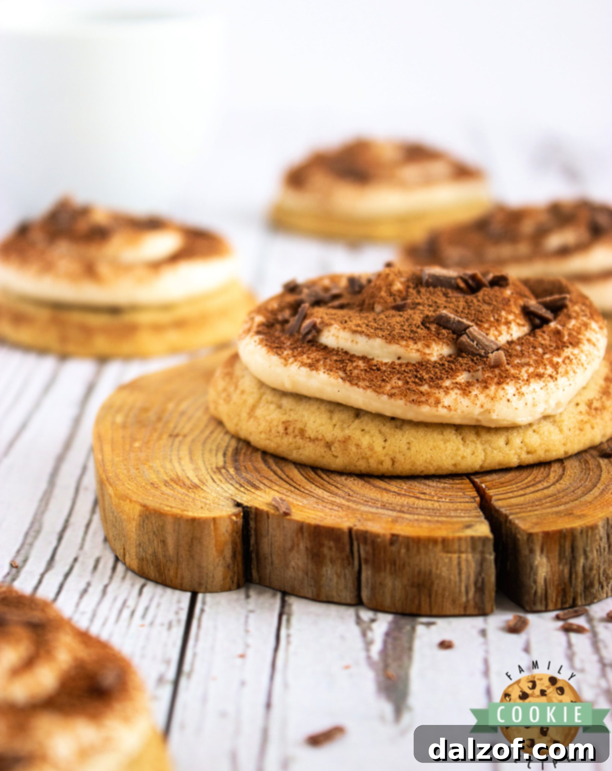 Cookies topped with mascarpone frosting and cocoa powder.
