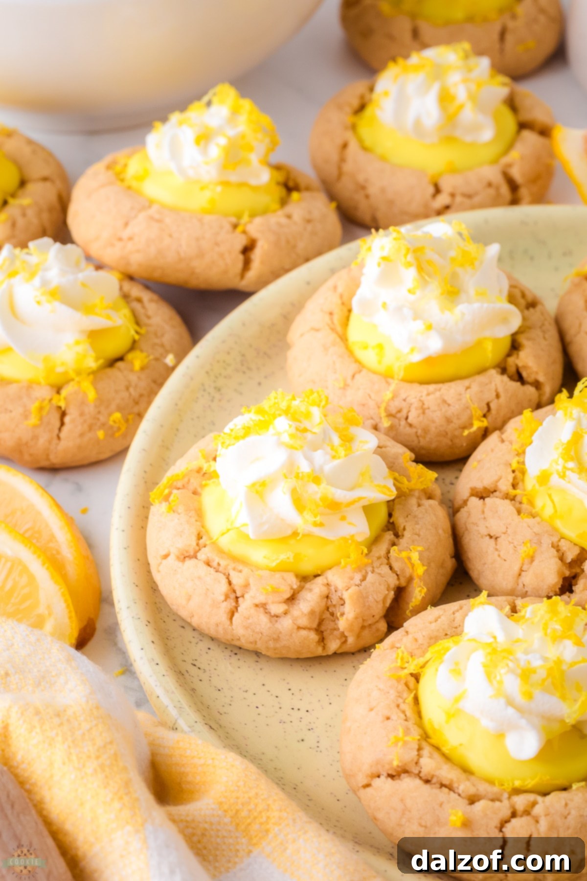 lemon pie cookies on a plate, showing the creamy lemon filling and fluffy whipped topping