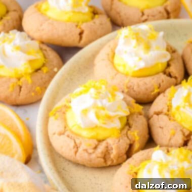 lemon pie cookies on a plate, featuring the bright yellow lemon filling and white whipped topping