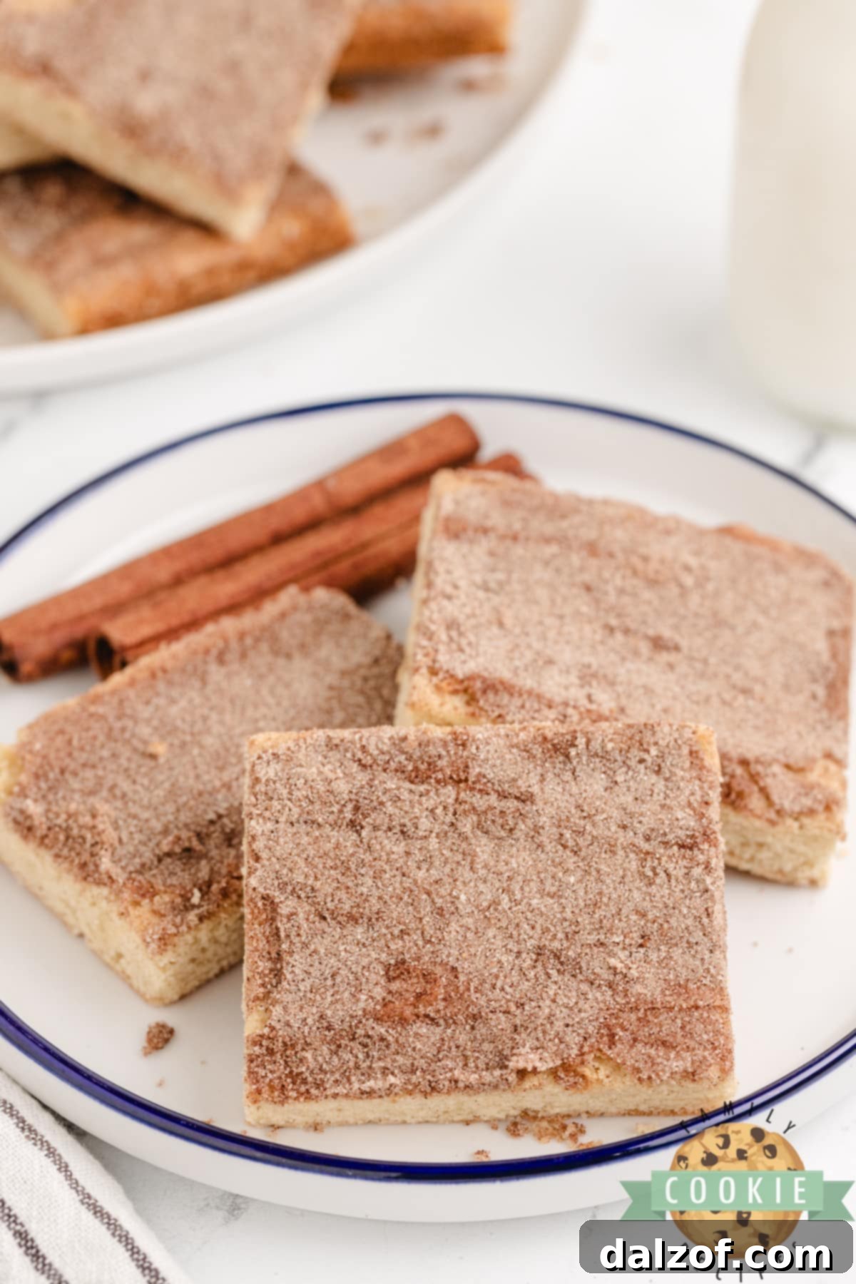Freshly baked Snickerdoodle Cookie Bars, perfectly cut into neat squares, arranged on a cooling rack.