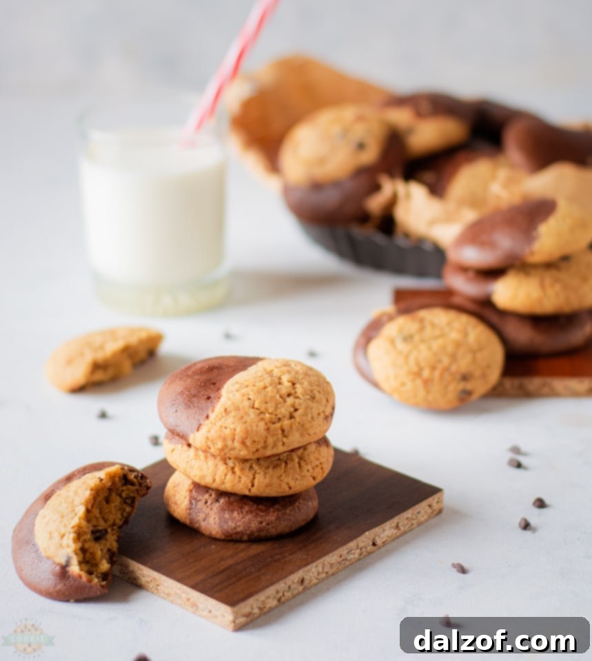 Hands rolling brownie and cookie dough together to form a Brookie cookie.