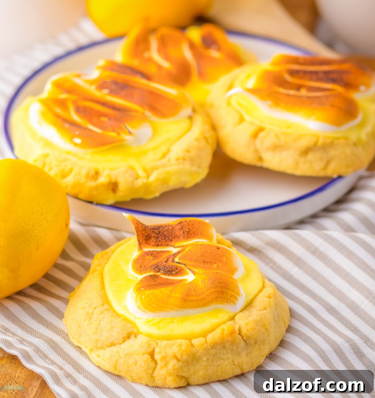 Lemon Meringue Pie Cookies artfully arranged on a dessert plate, showcasing their perfect shape and golden meringue