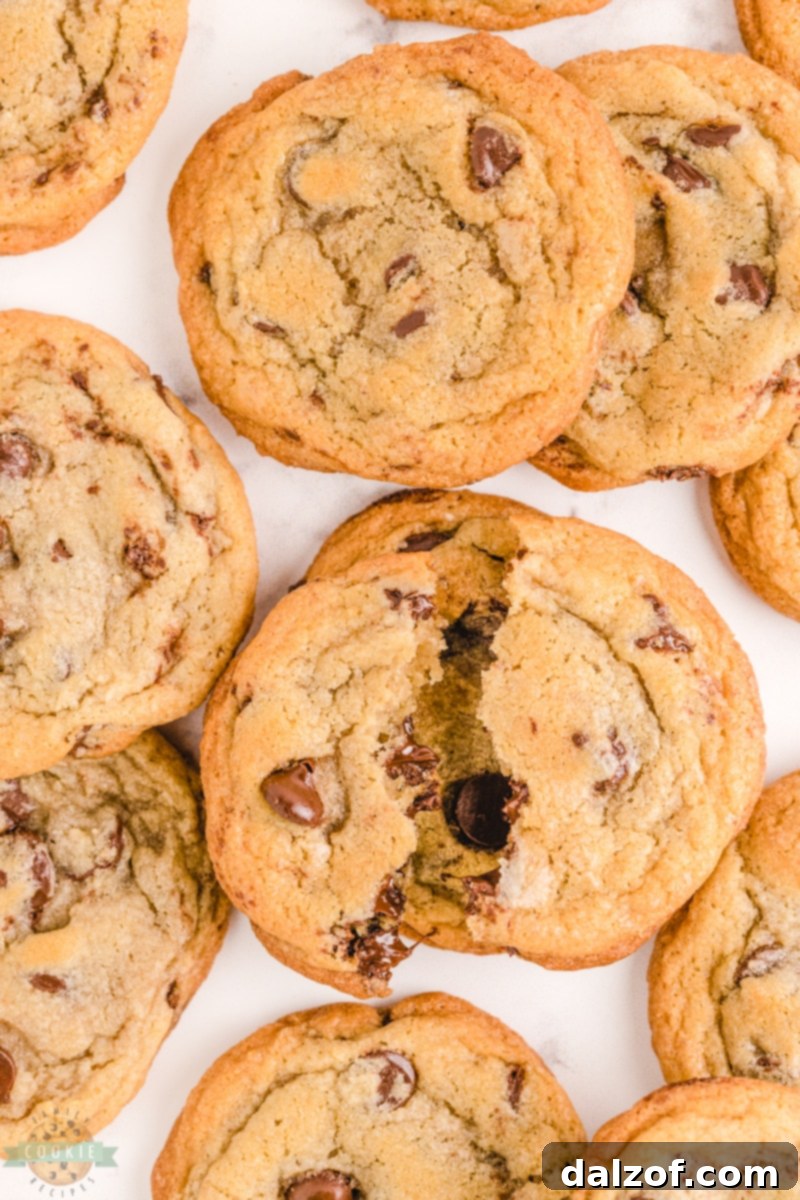 Close-up of a stack of golden brown Nestle Toll House chocolate chip cookies