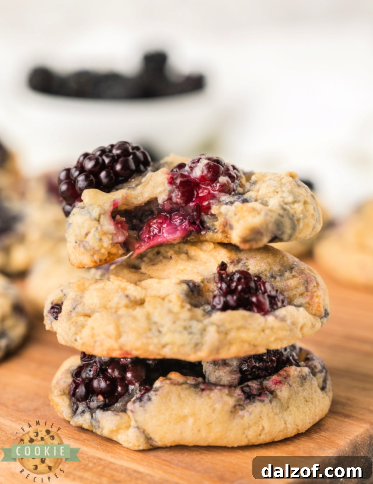 A stack of soft and chewy Blackberry Cookies with visible fresh blackberries and a zesty lemon aroma, freshly baked and ready to eat.