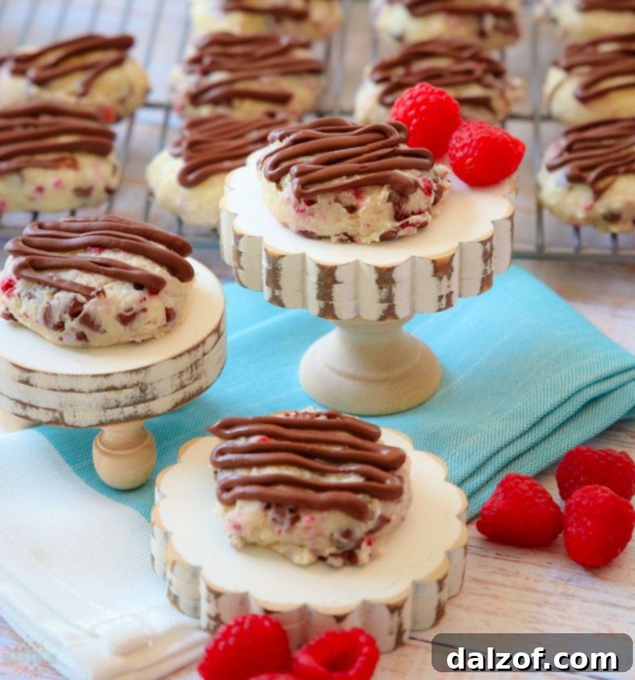 Stacked Chocolate Raspberry Cheesecake Cookies on a white plate, ready to be served.