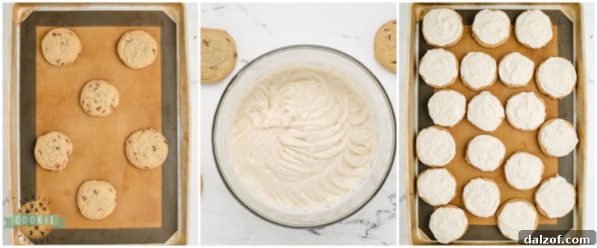 Hands carefully spreading smooth vanilla frosting onto a freshly baked cinnamon chip cookie, creating a beautiful, even layer.