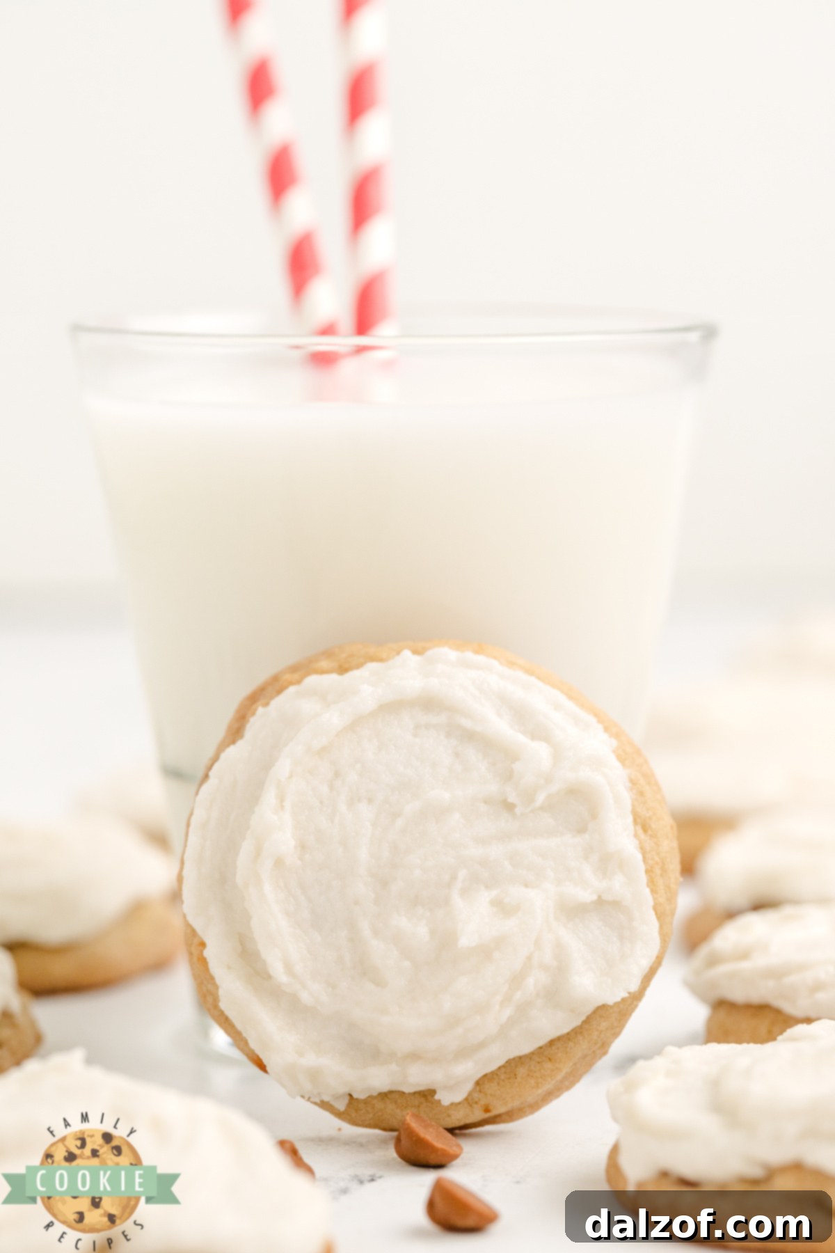 A beautifully frosted Iced Cinnamon Chip Cookie presented next to a tall glass of cold milk, highlighting its soft texture and inviting appearance, perfect for a sweet treat.