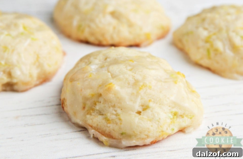 A close-up shot of Lemon Zucchini Cookies, showing a bite taken out to reveal the moist, tender interior