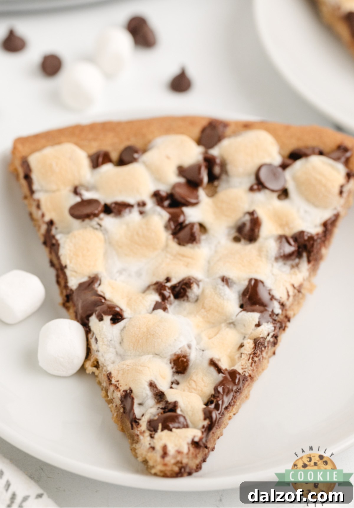 Peanut butter cookie pizza topped with chocolate chips and marshmallows.
