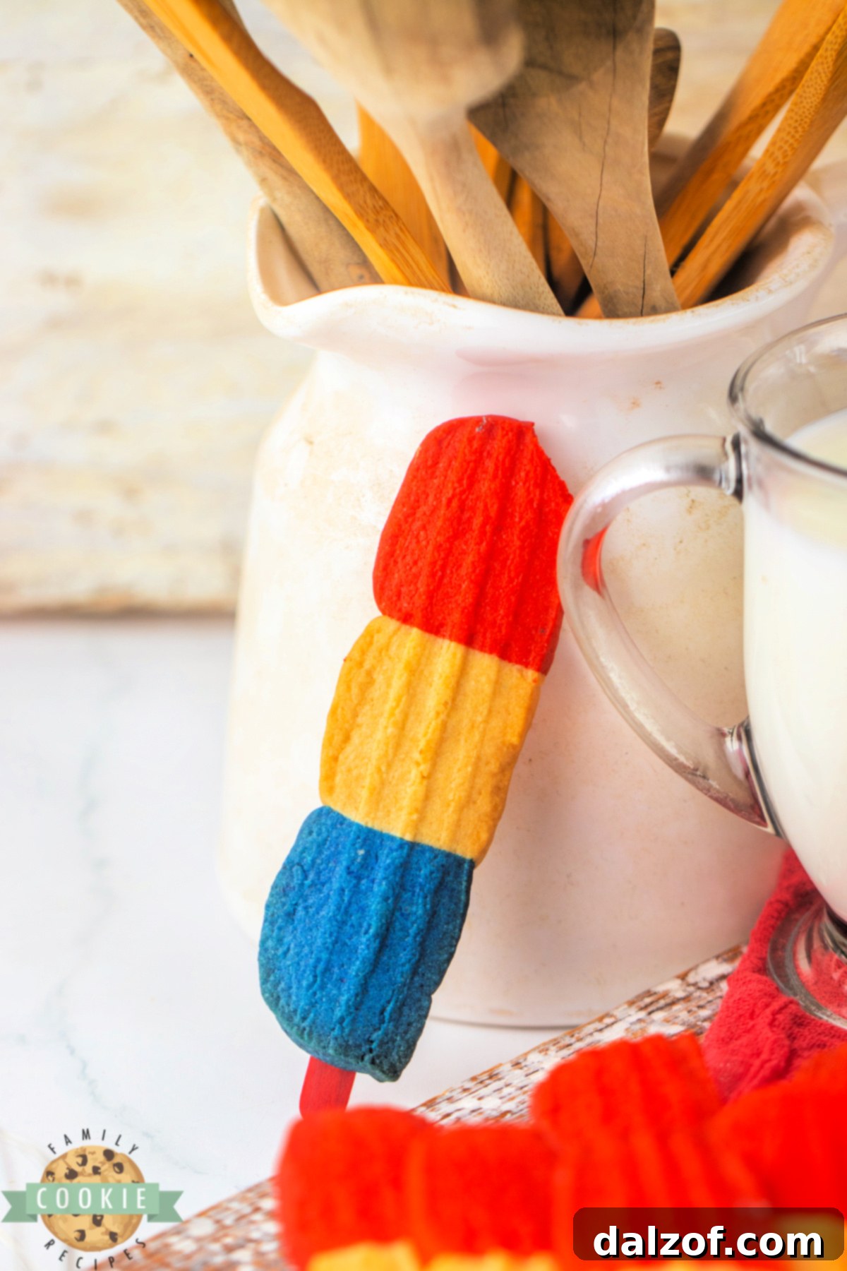 Red, white, and blue cookie on a popsicle stick.