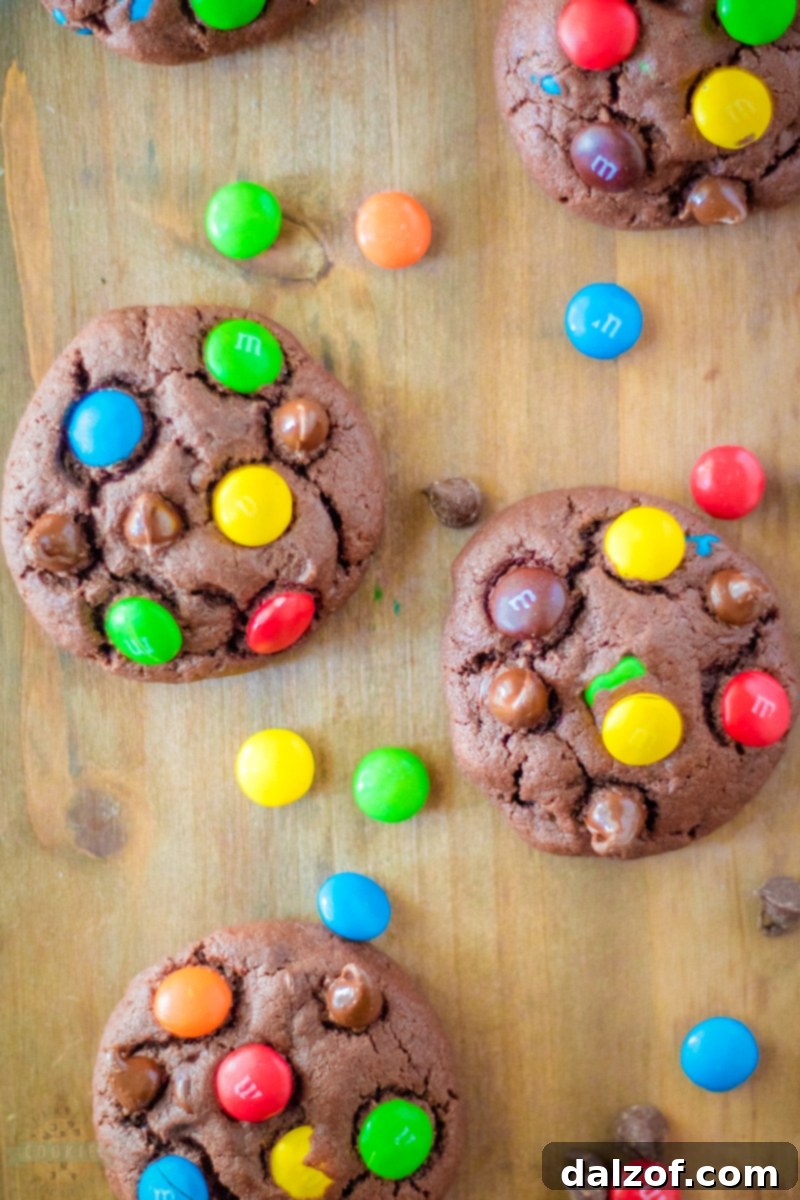 Close-up of unbaked cookie dough with M&M candies.