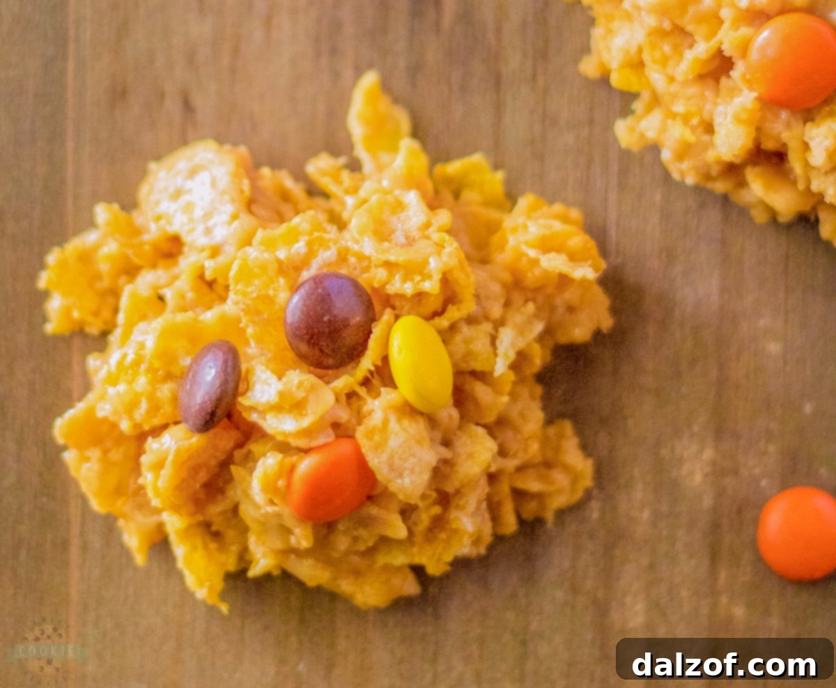 Delicious Reese's Peanut Butter Cornflake Cookies, topped with colorful Reese's Pieces candy.