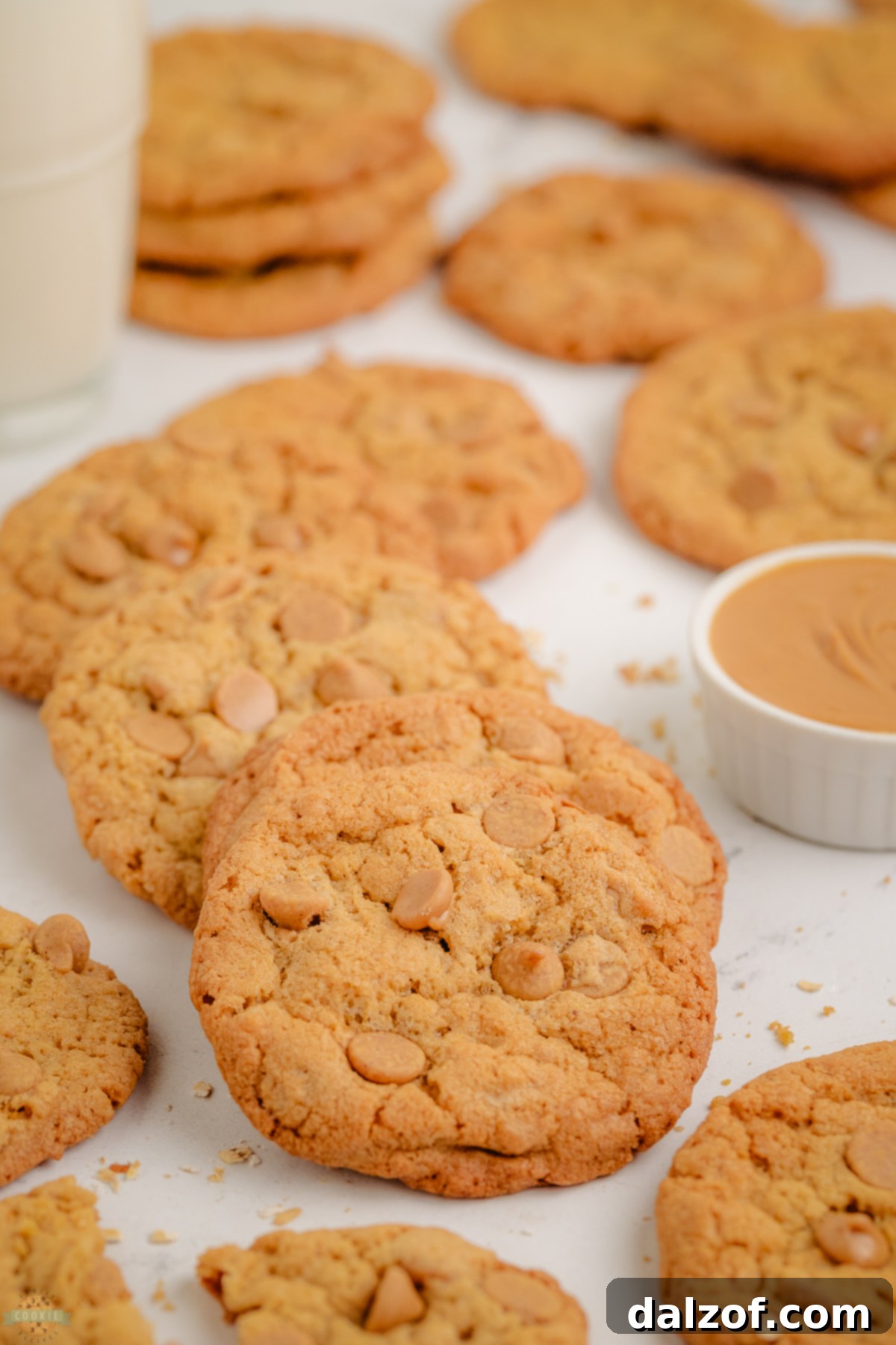 A fresh batch of peanut butter maple cookies cooling on a wire rack, ready to be devoured.