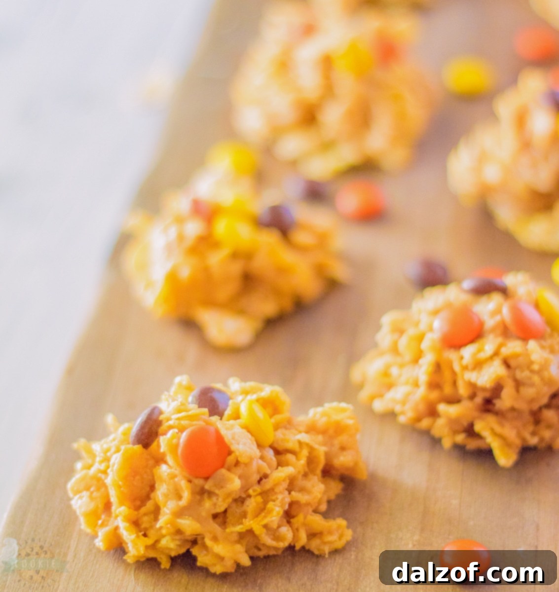 Assortment of no-bake cornflake cookies with Reese's Pieces on a cooling rack