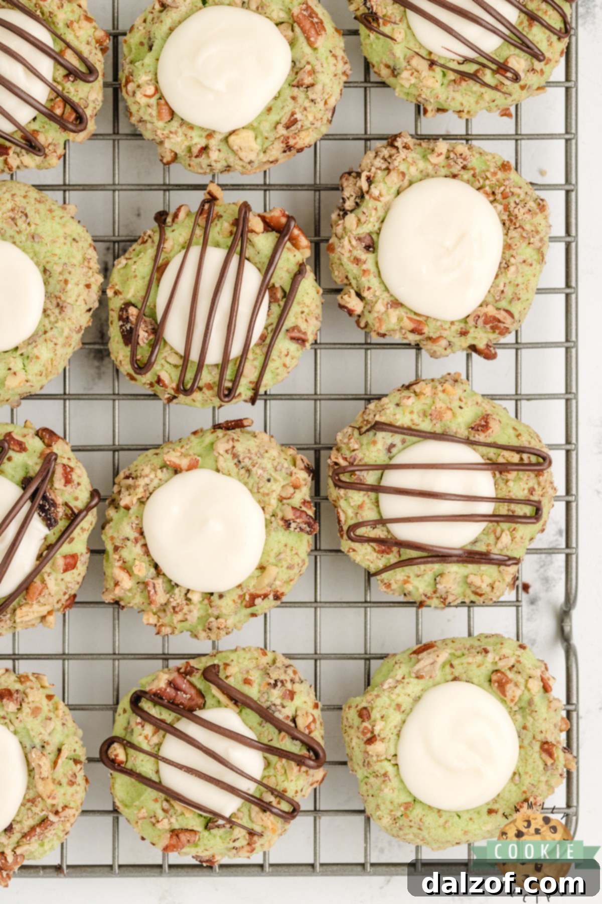 Pistachio Thumbprint Cookies on a wire rack. 