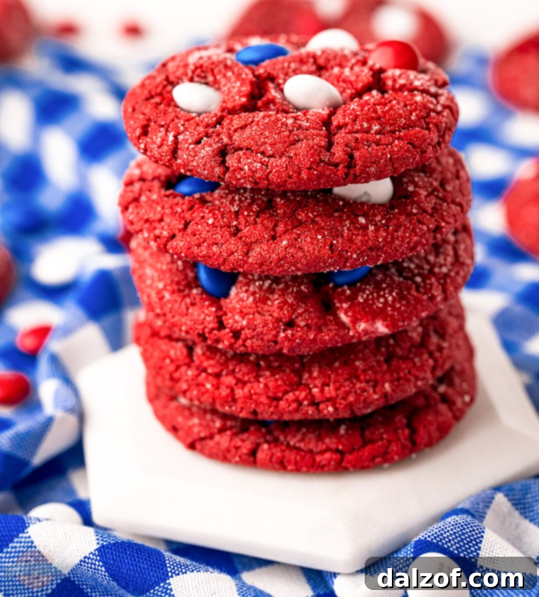 Cooling red velvet cake mix cookies with patriotic M&Ms on a wire rack