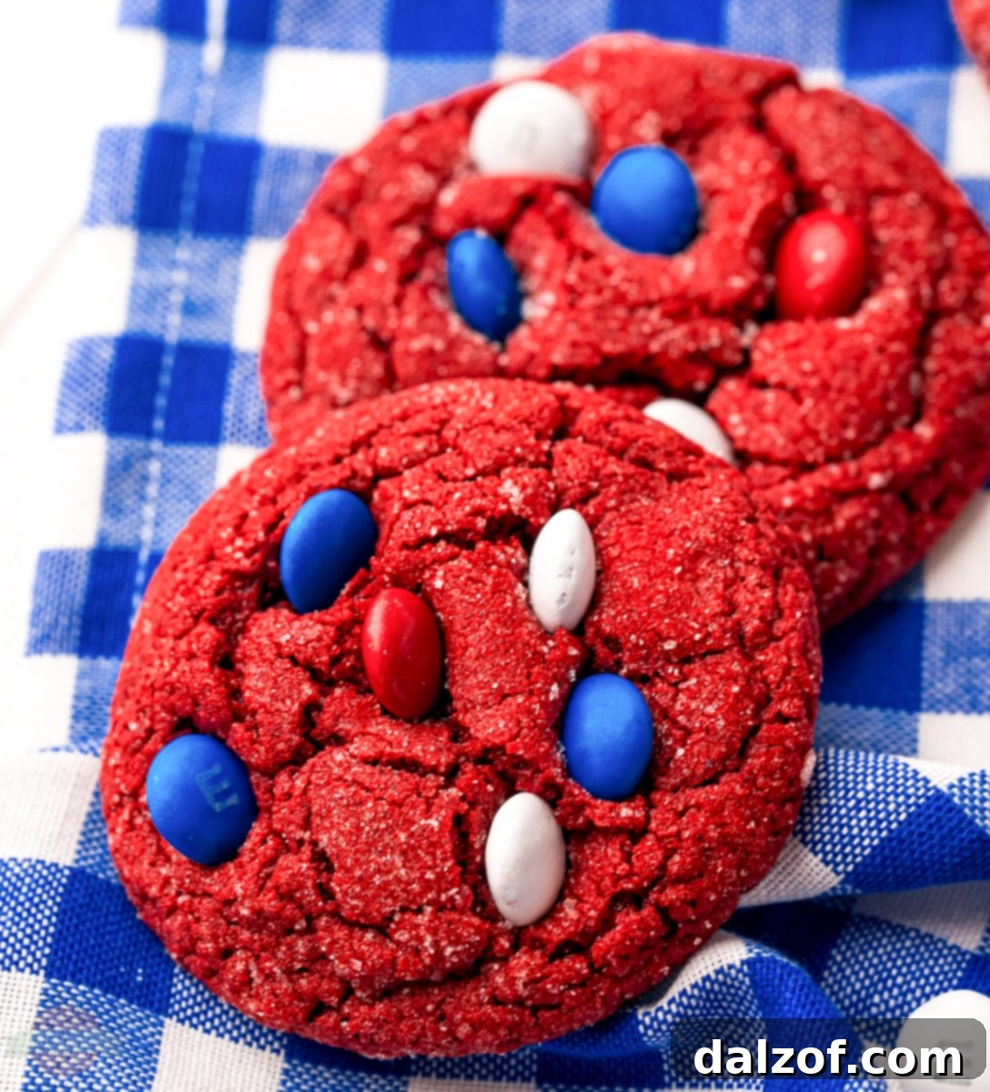 Close-up of baked red velvet cookies with patriotic M&Ms on a white tray