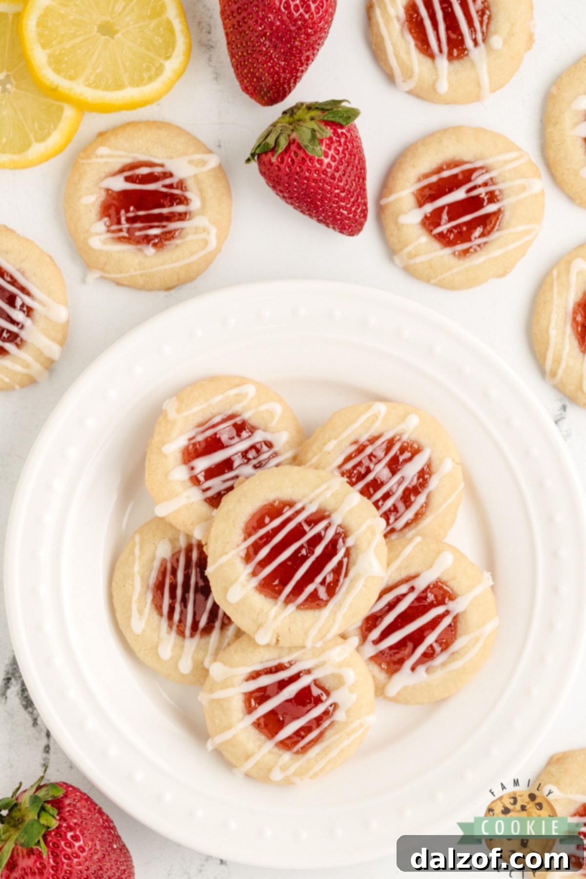 Lemon thumbprint cookies with strawberry filling and lemon glaze.