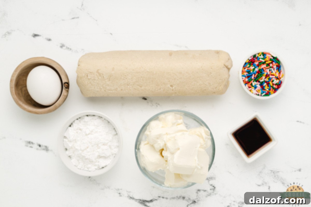 Ingredients in Cheesecake Sugar Cookie Bars, showing cream cheese, egg, vanilla extract, powdered sugar, and cookie dough.