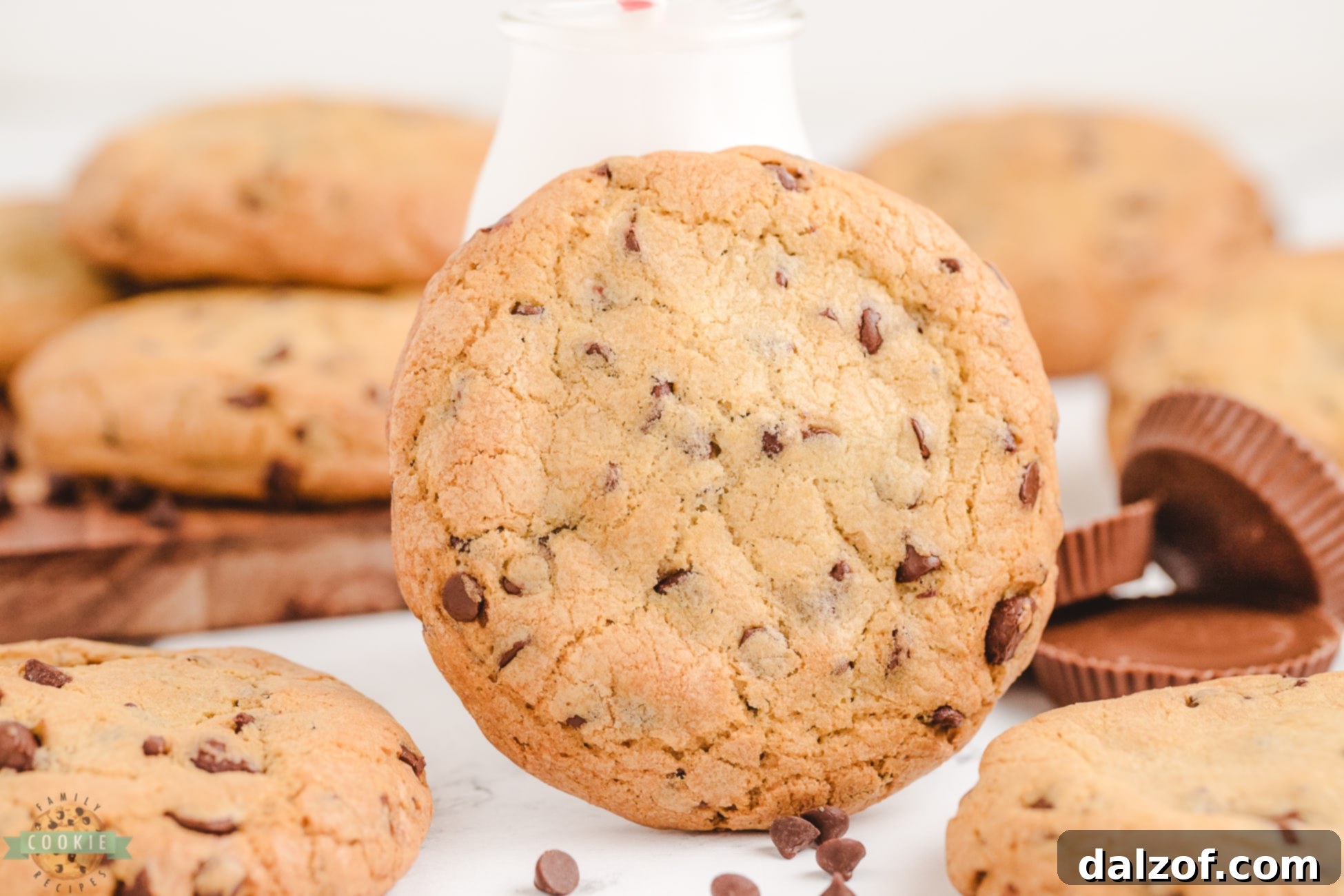 Close-up of freshly baked Reese's stuffed cookies with melted chocolate chips visible and a hint of the peanut butter cup center.