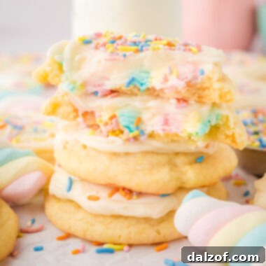 rainbow marshmallow surprise cookies topped with frosting