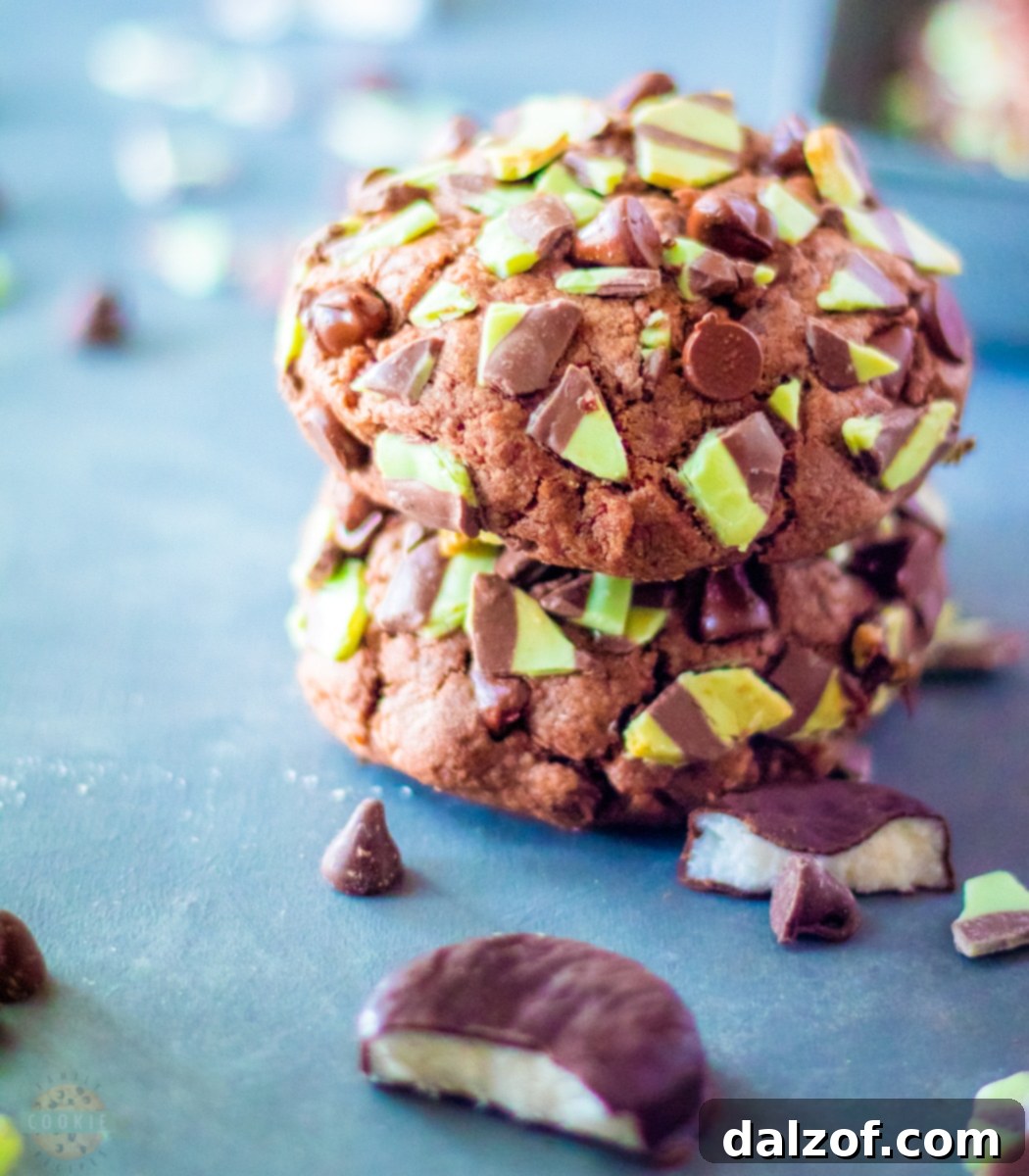 A close-up of a stack of Big, Fat Mint Chocolate Chip Cookies, showcasing their generous size and rich, chocolatey texture.