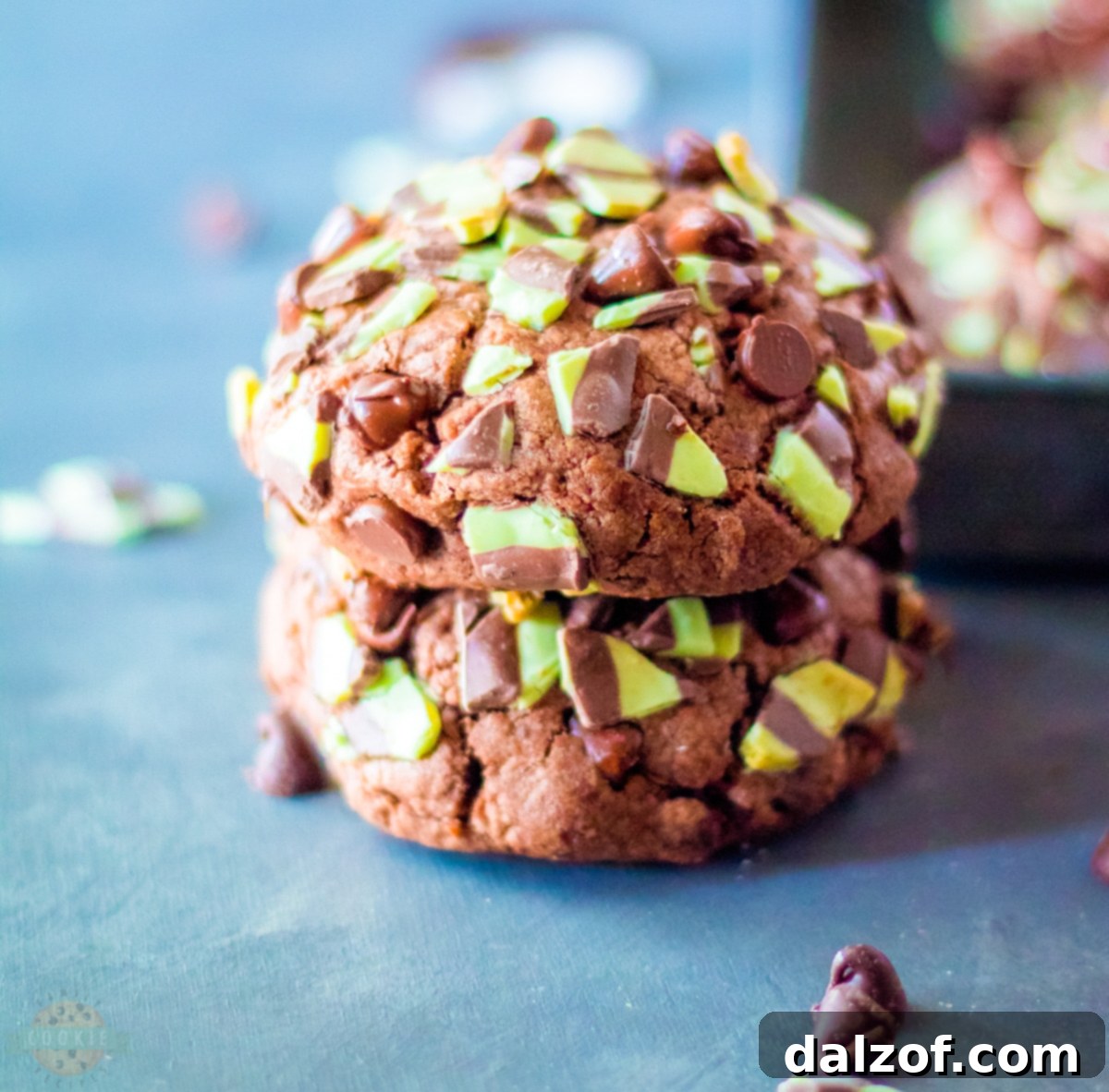 A close-up shot of a single Big, Fat Mint Chocolate Chip Cookie, showing its beautiful texture and melted chocolate chips.