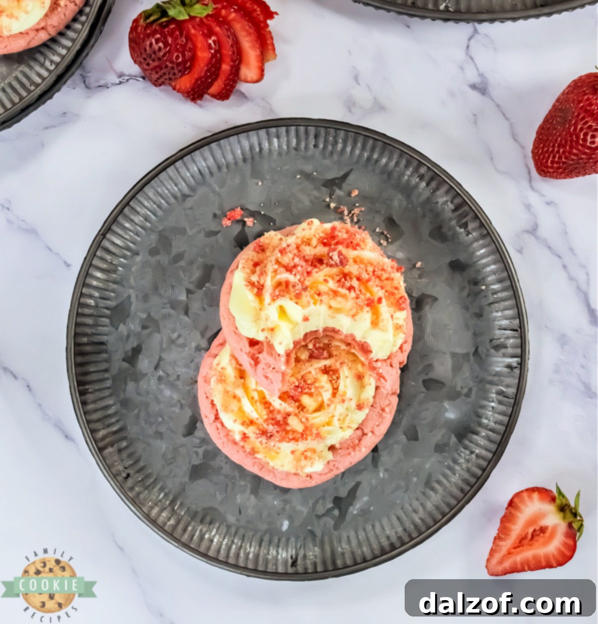 Strawberry cookies with vanilla frosting and strawberry streusel on top.