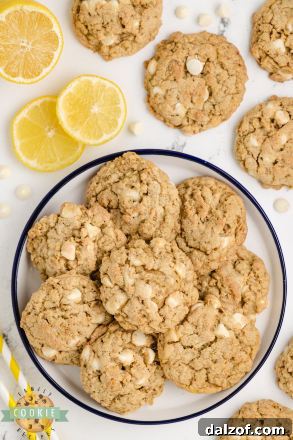 Oatmeal cookies made with lemon pudding and white chocolate chips cooling on a wire rack.