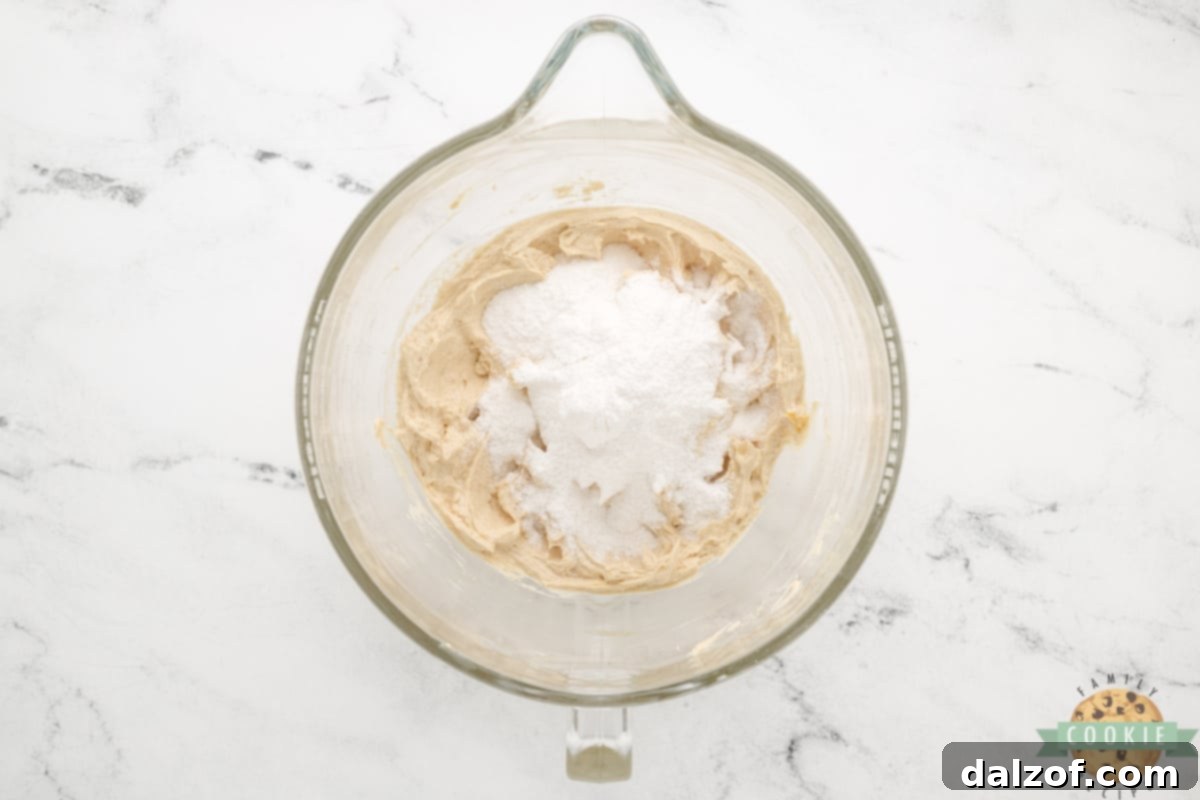 Adding dry lemon pudding mix to the creamed cookie dough.