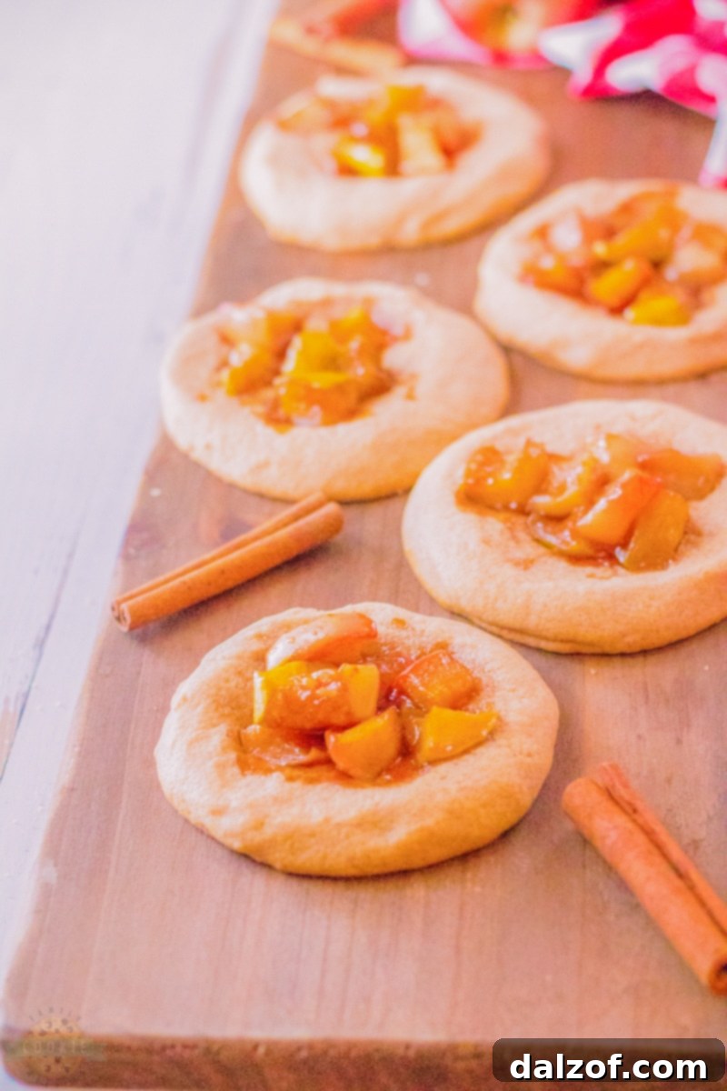 A batch of baked apple pie cookies on a tray