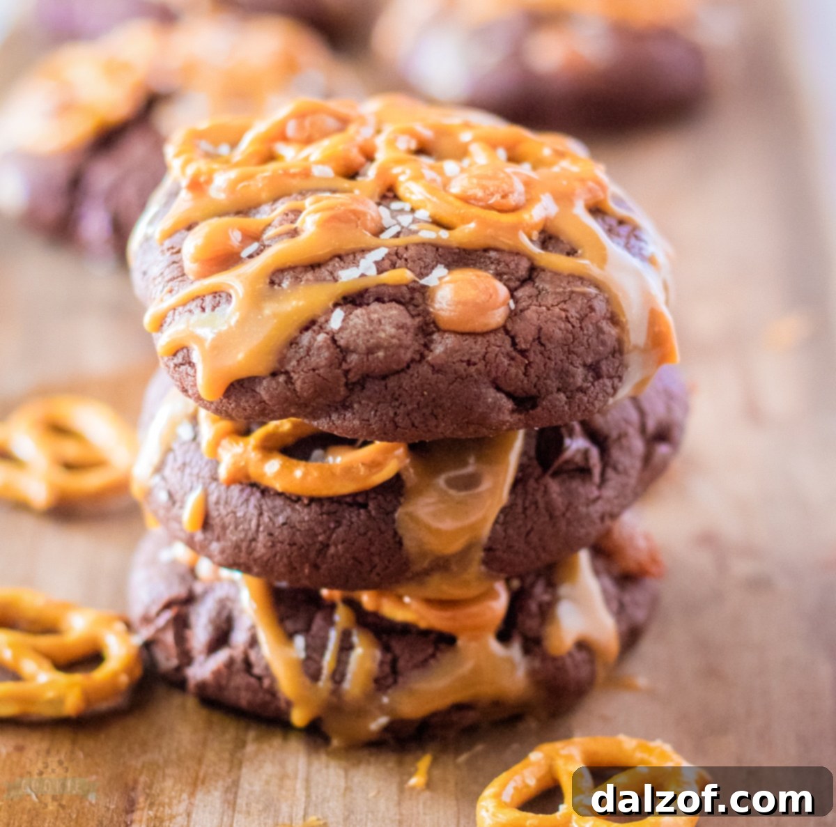Plate of freshly baked Salted Caramel Brownie Cookies drizzled with caramel sauce