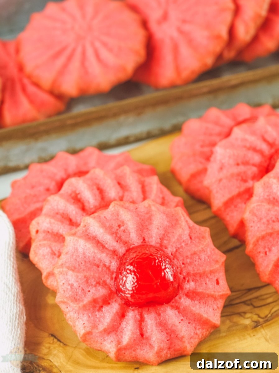 Stacked Cherry Jello Cookies with a few maraschino cherries