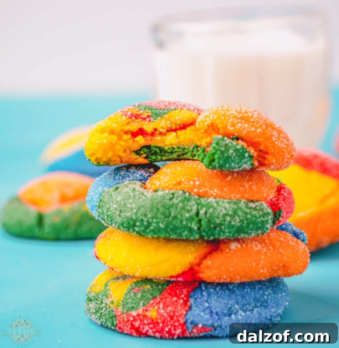 Close-up of freshly baked rainbow cake mix cookies on a cooling rack, highlighting their soft texture and vibrant swirls of color.