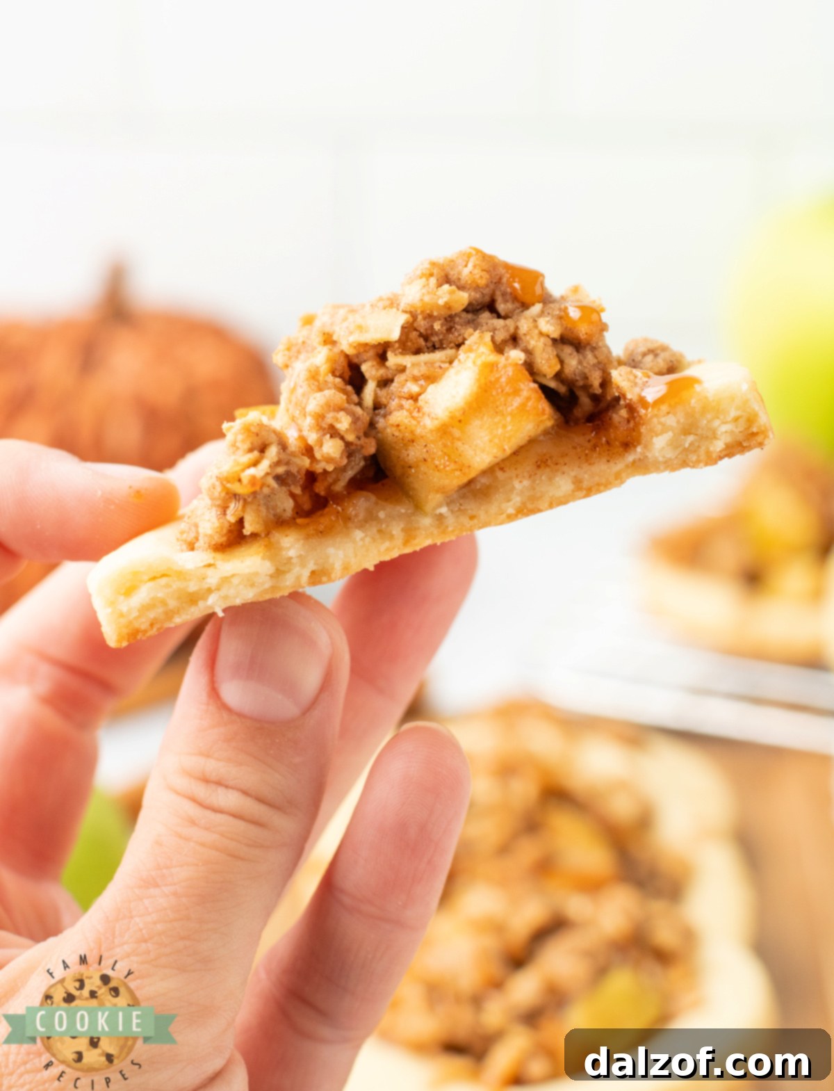 Hand holding half of an Apple Crumble Cookie.
