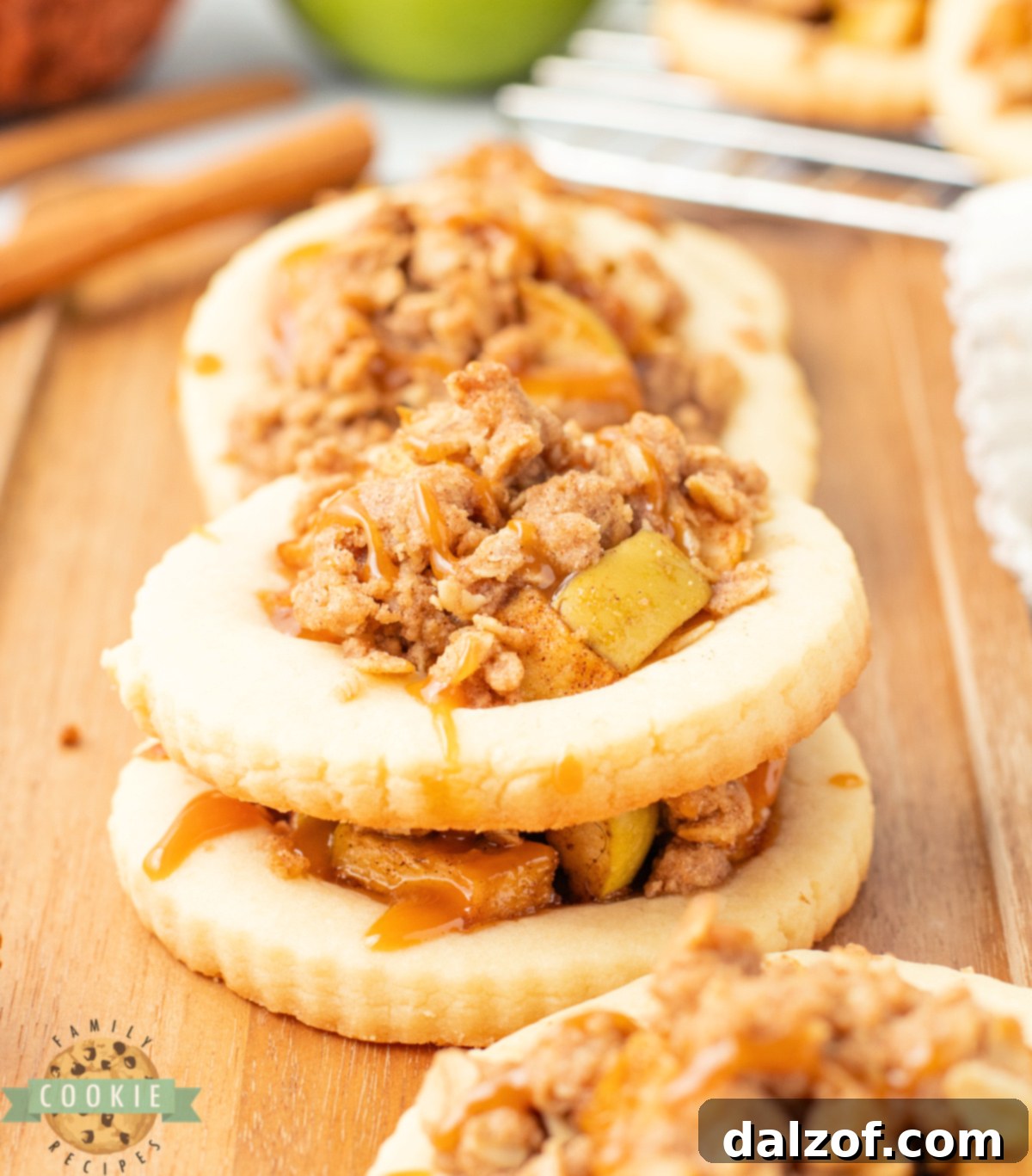 Apple Crumble Cookies are filled with cinnamon-spiced apples, topped with a buttery oat crumble, and drizzled with caramel.