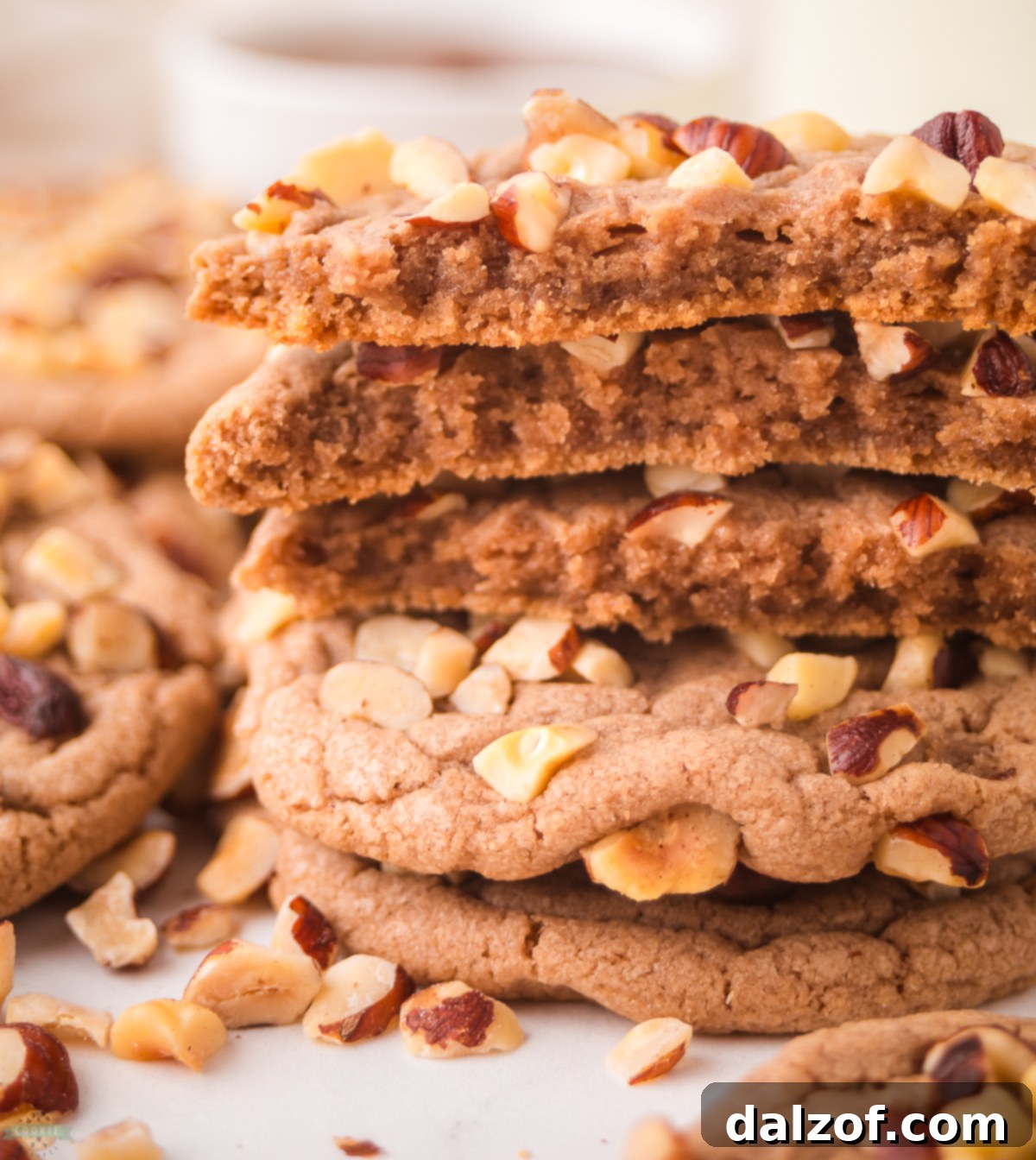 A chocolate hazelnut cookie cut in half, revealing its soft interior.