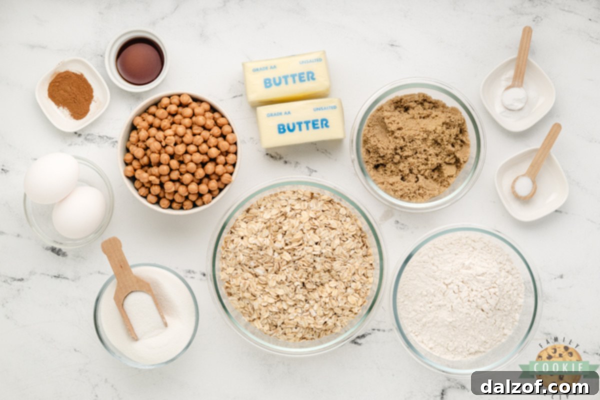 A selection of high-quality ingredients for baking Caramel Oatmeal Cookies, including oats, flour, and caramel bits.