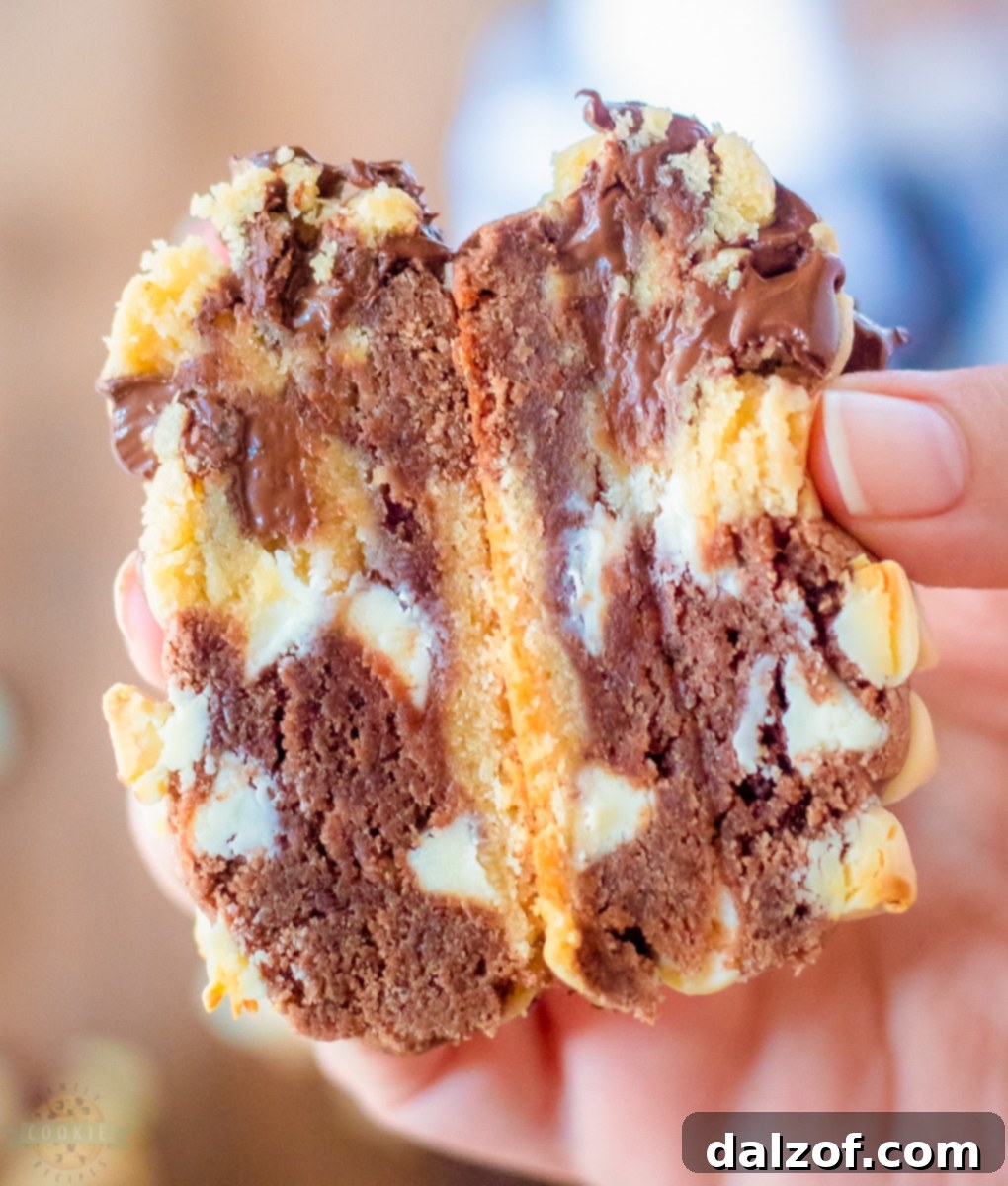 Four giant marbled chocolate chip cookies cooling on a wire rack.