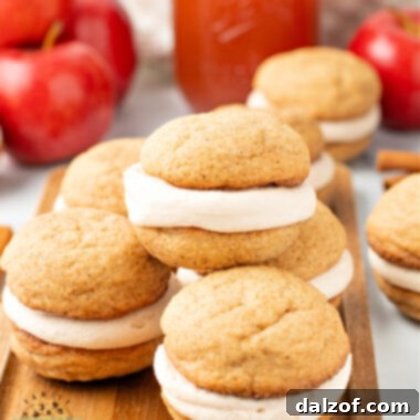 Creamy Apple Cider & Snickerdoodle Delight Pies 7 Stack of soft and chewy apple cider snickerdoodle cream pies showing the frosting layer inside.