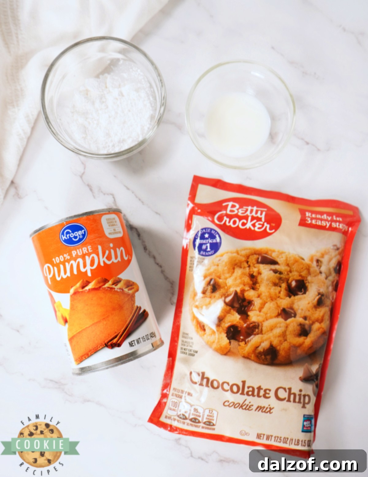 Key ingredients for Pumpkin Chocolate Chip Cookie Bars recipe laid out: cookie mix, pumpkin puree, powdered sugar, and milk.