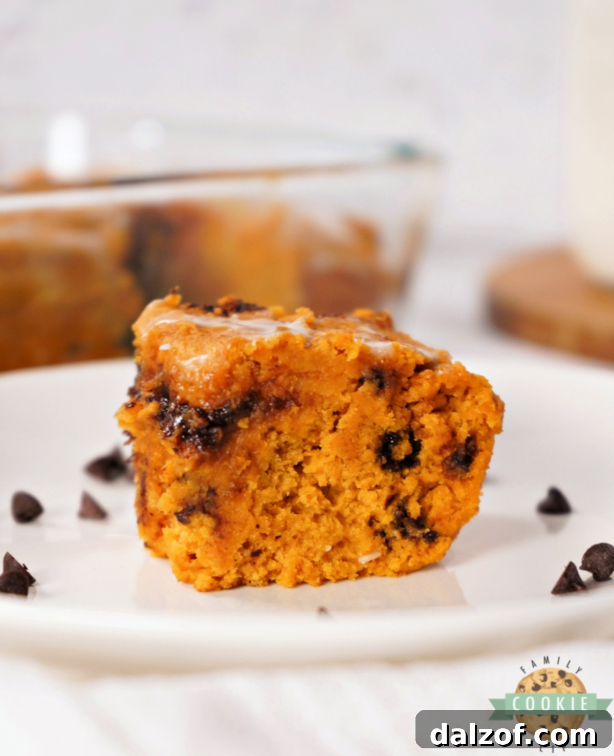Close-up of golden cookie mix pumpkin bars with a delicate powdered sugar icing drizzle.