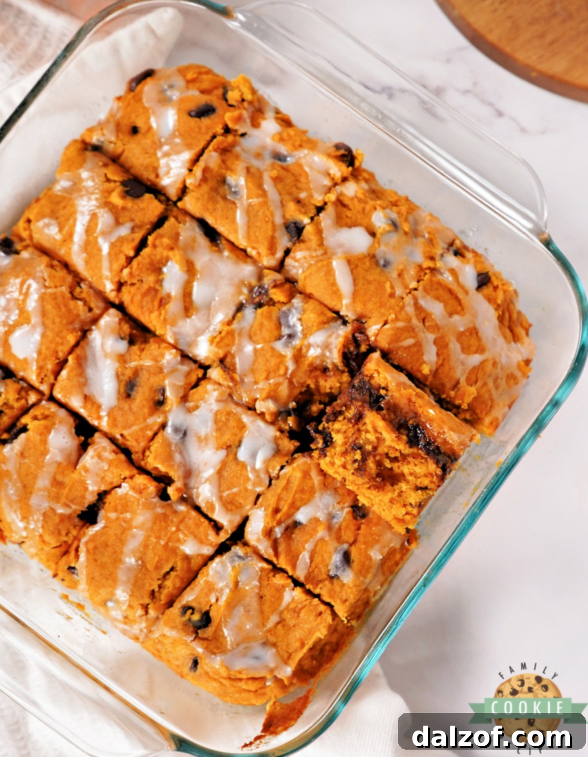 Easy pumpkin dessert bars cut into tidy squares with a delicate glaze drizzle, perfect for sharing.