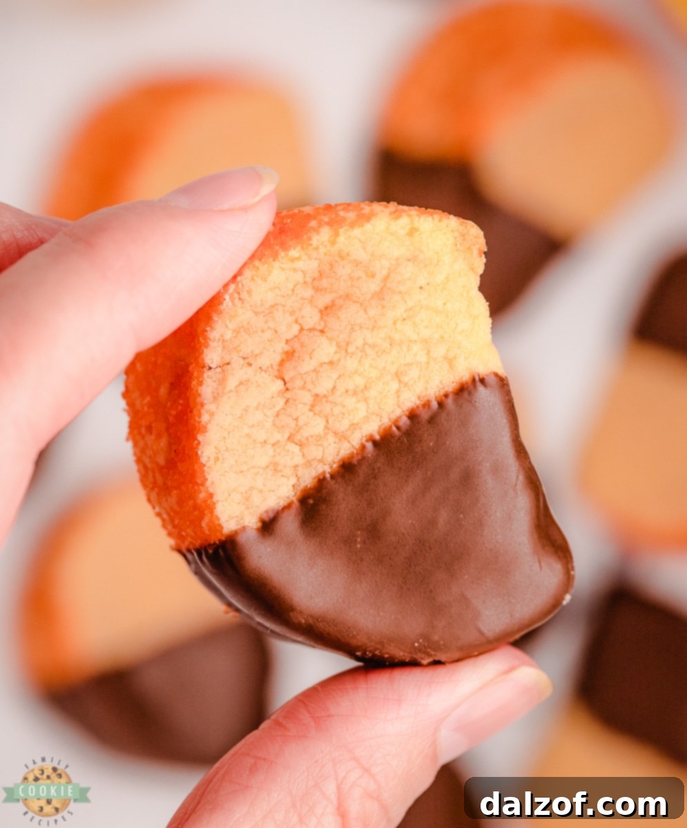 holding an orange slice cookie