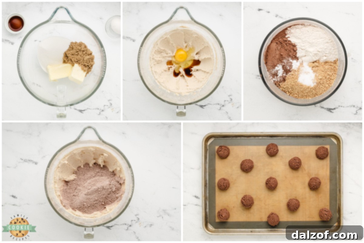 A close-up shot of raw Chocolate Graham Cracker Cookie dough scooped onto a baking sheet, ready for the oven.